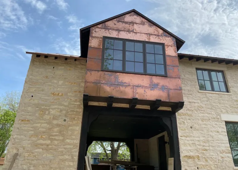 Copper metal panel facade on a stone building for Skylight Installation in Vermilion