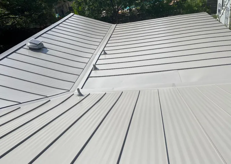 Solar attic fan installed on a metal roof for Roof Ventilation in Vermilion